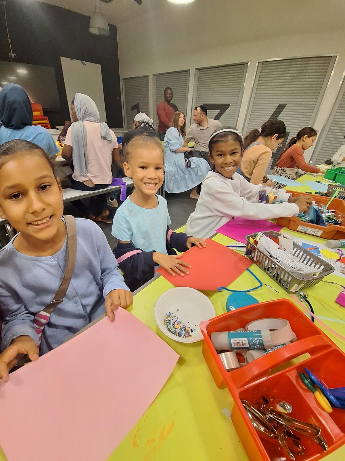 Children smiling during a craft workshop