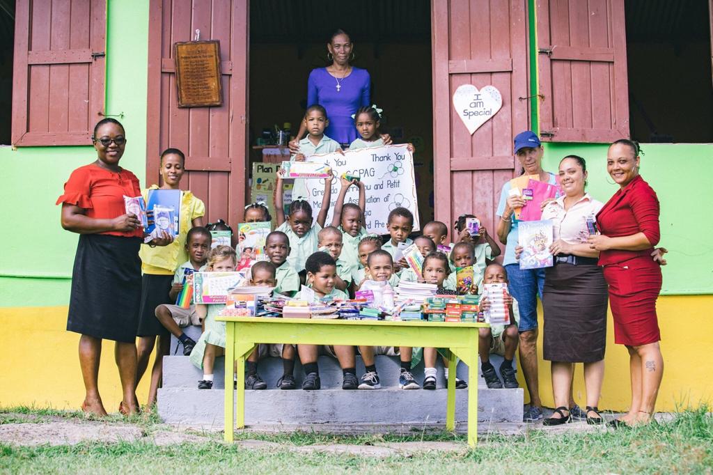 School children and teachers in Grenada with donated supplies