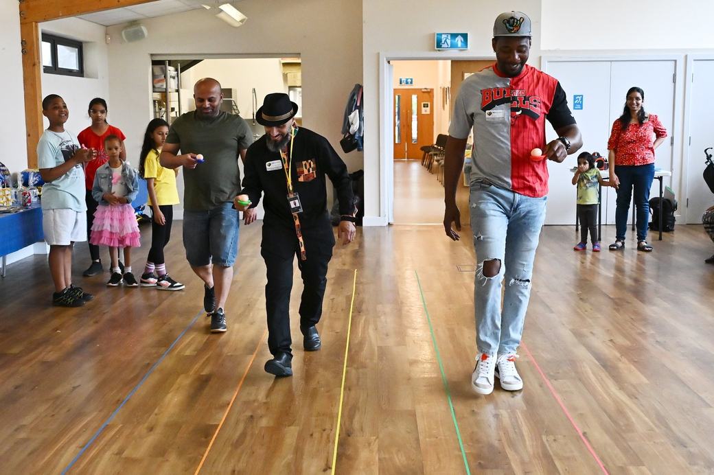 Adults and children taking part in indoor games