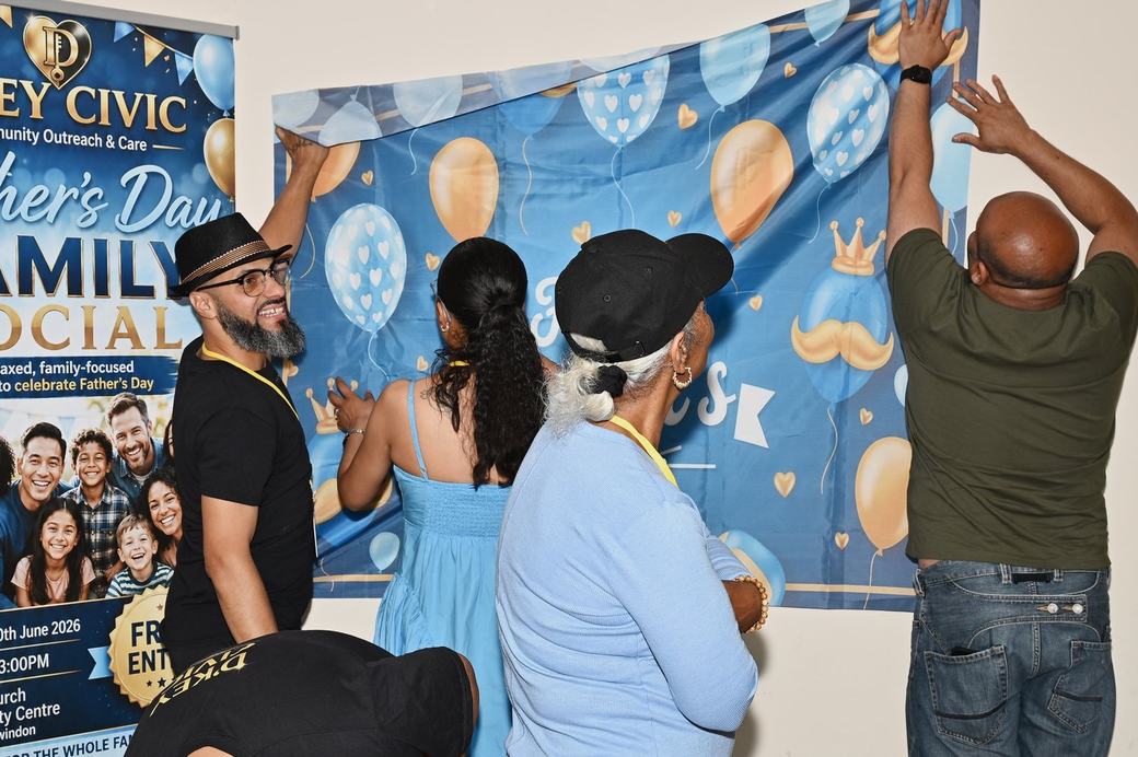 Families preparing to take photos in front of the Father’s Day backdrop