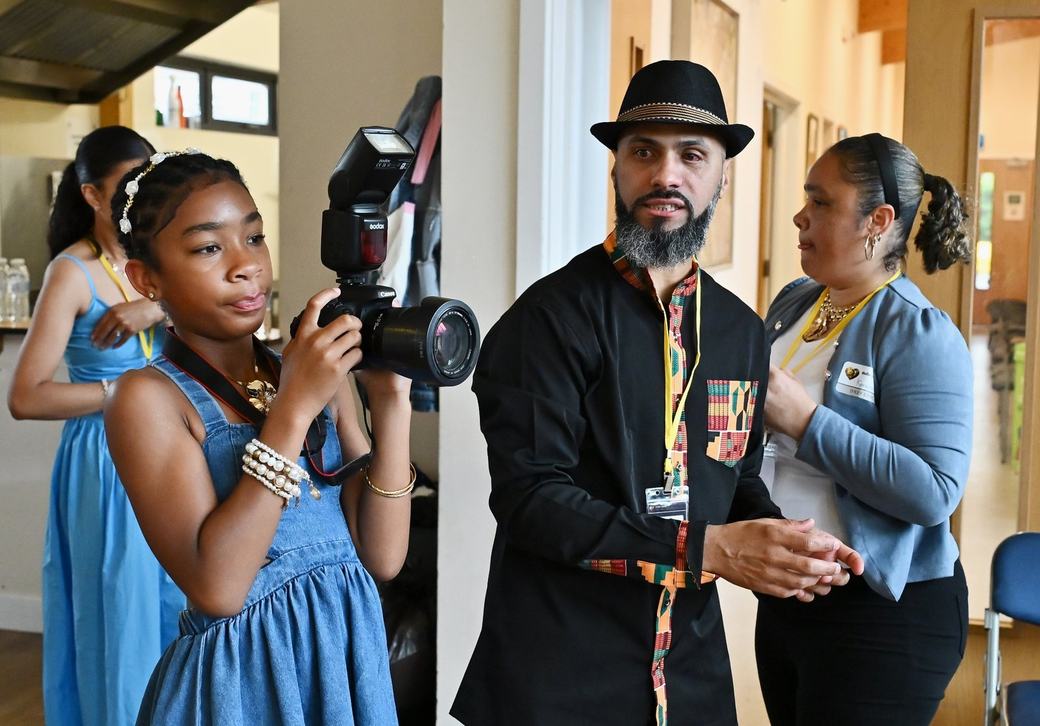 Young photographer beside D’Key Civic team members during the event