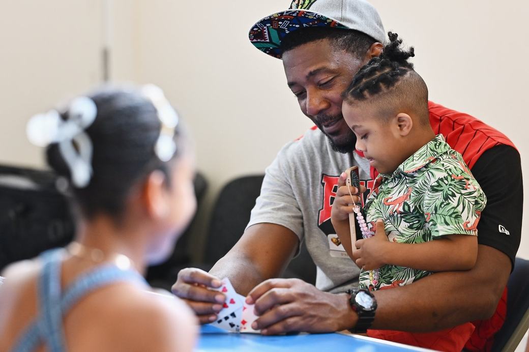 Father and child taking part in a card activity at the Father’s Day Family Social