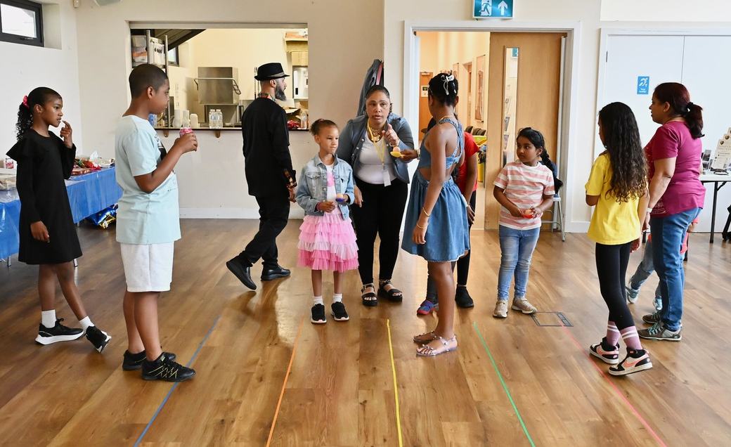 Children and adults preparing for games at the Father’s Day event