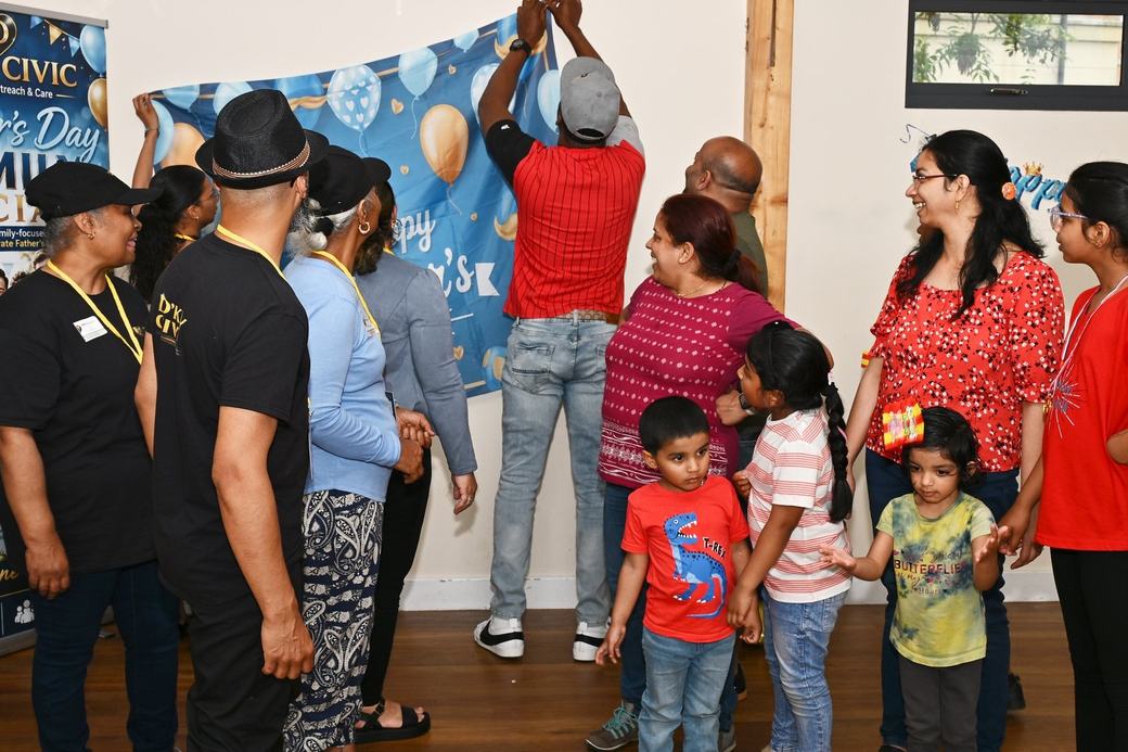 D’Key Civic team and families arranging the Father’s Day photo backdrop
