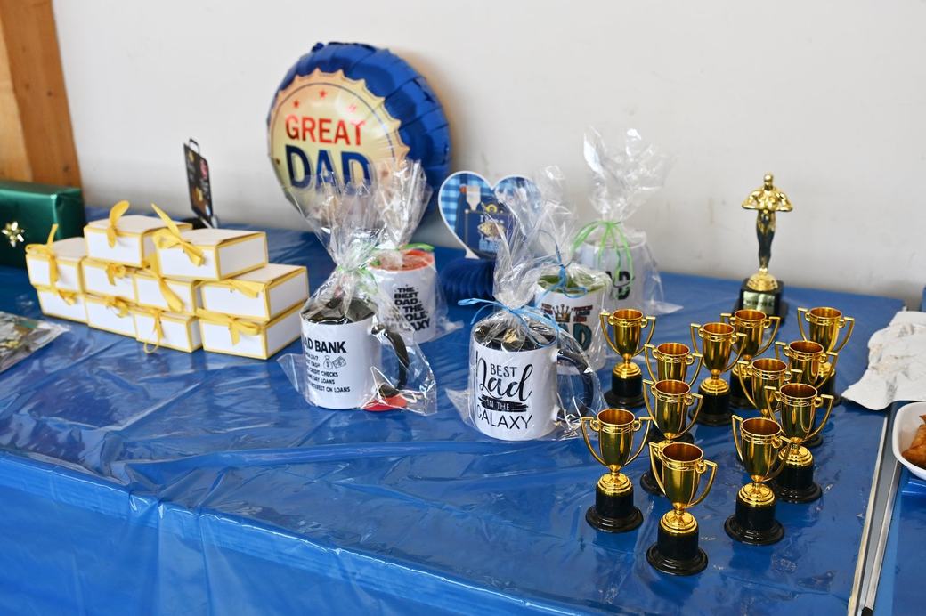 Father’s Day prizes, certificates and event items laid out on a table