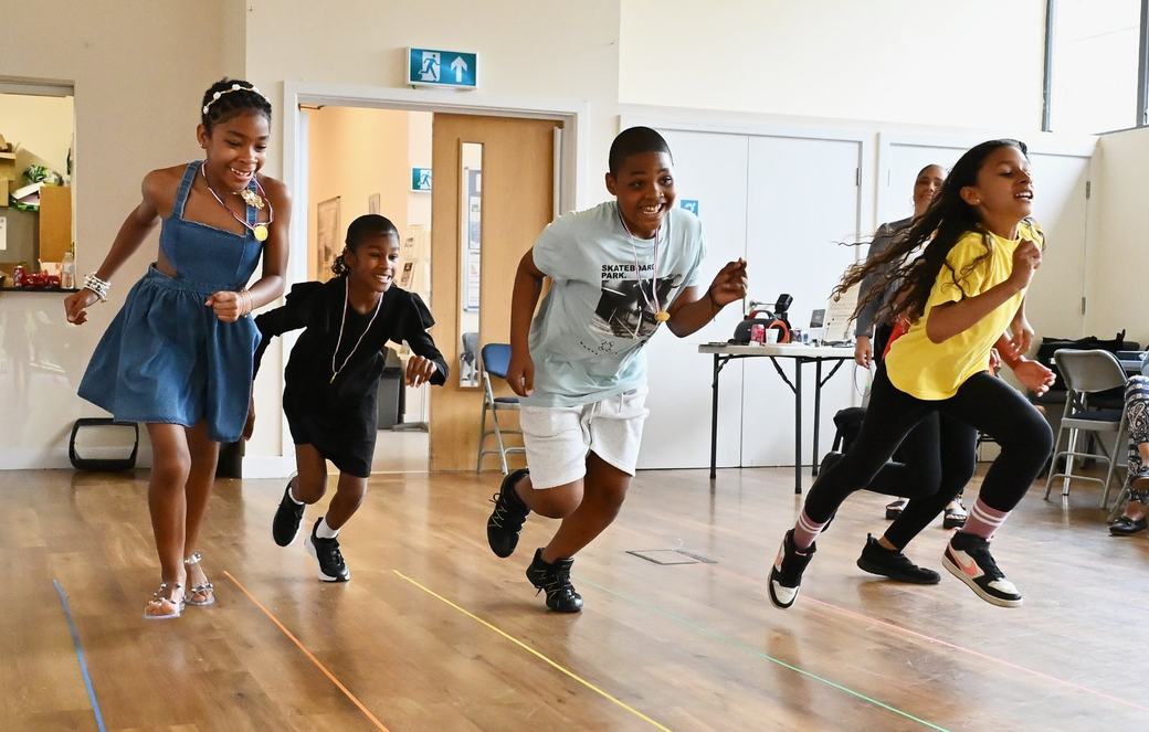 Children running during a family activity at the Father’s Day event