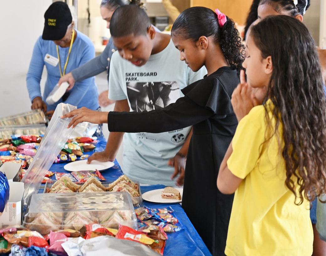 Children and families selecting refreshments at the Father’s Day event