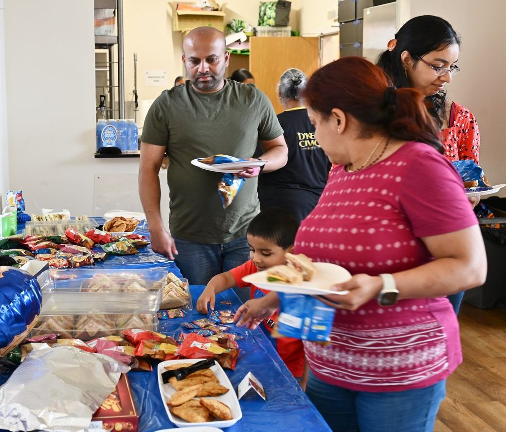 Families collecting food and refreshments during the Father’s Day event