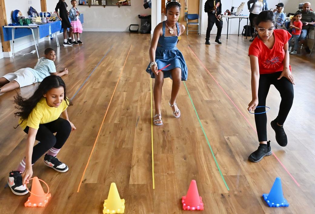 Children playing a ring toss activity at the Father’s Day event
