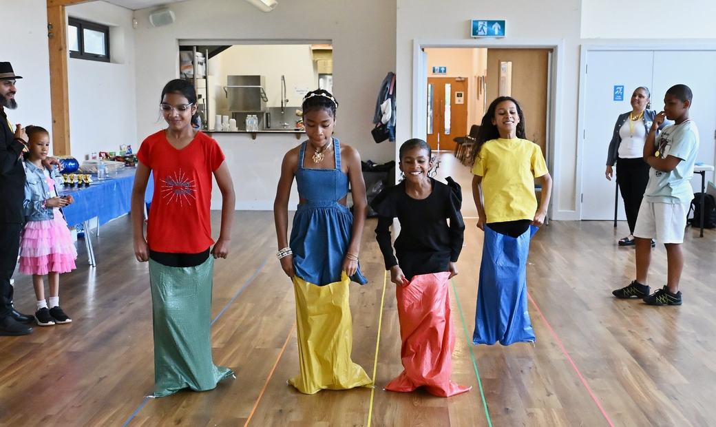 Children taking part in a sack race activity at the Father’s Day event