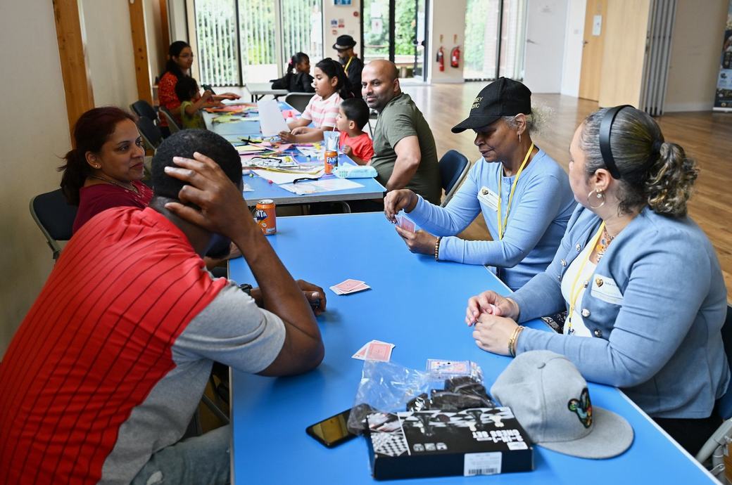 Families and D’Key Civic team members around a table during the event