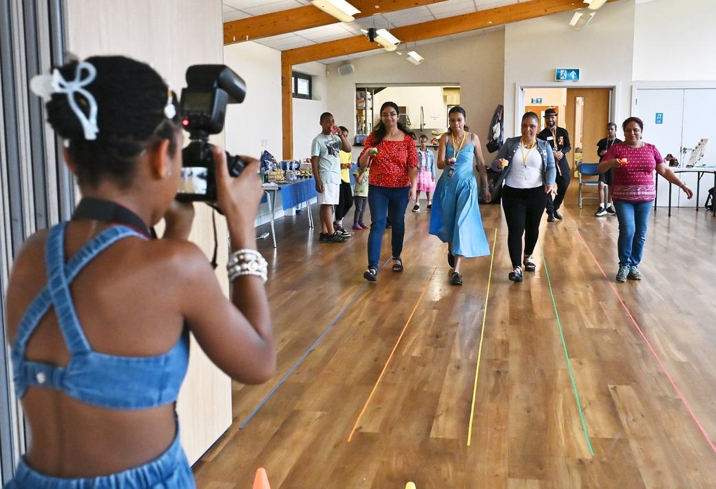 Young participant taking photographs during the Father’s Day activity session